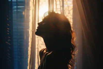 Silhouette Of A Woman Standing By A Window