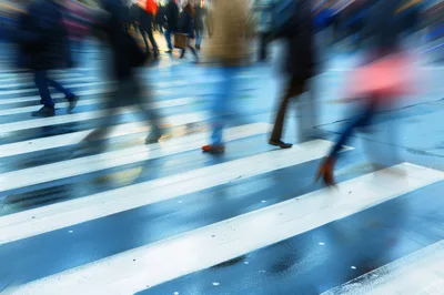 Motion Blur Pedestrians Crossing A Wet City Street