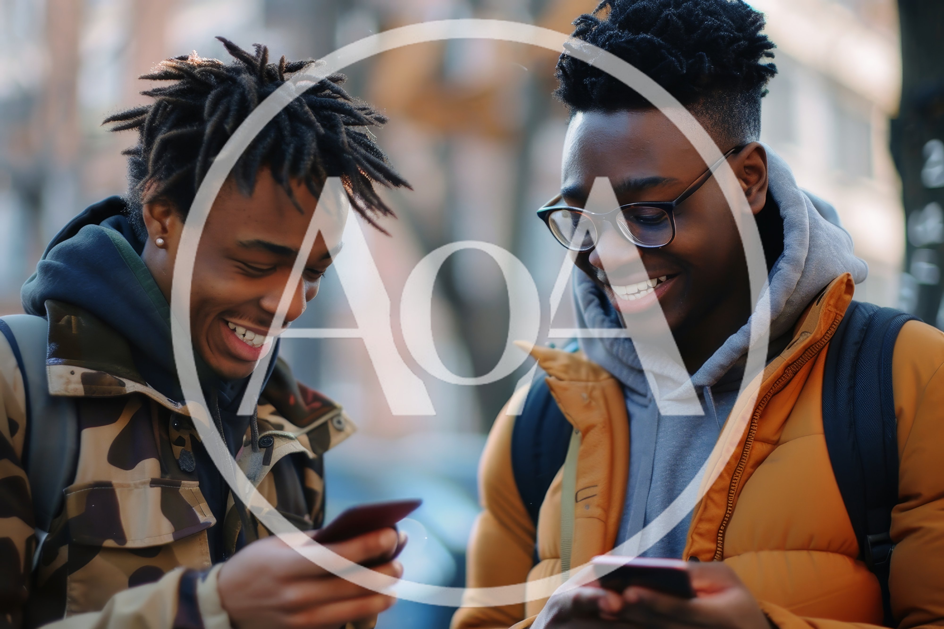 Two Young Men Laughing While Using Smartphones Outdoors