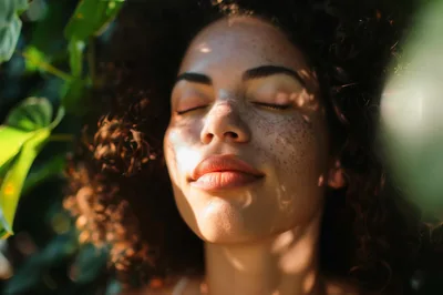 Young Woman With Curly Hair Enjoying Sunlight Outdoors