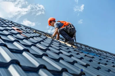 Construction Worker Installing Metal Roofing Tiles