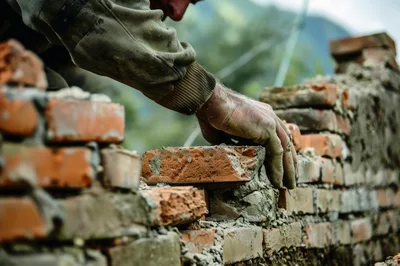 Bricklayer Laying Red Bricks On A Construction Site