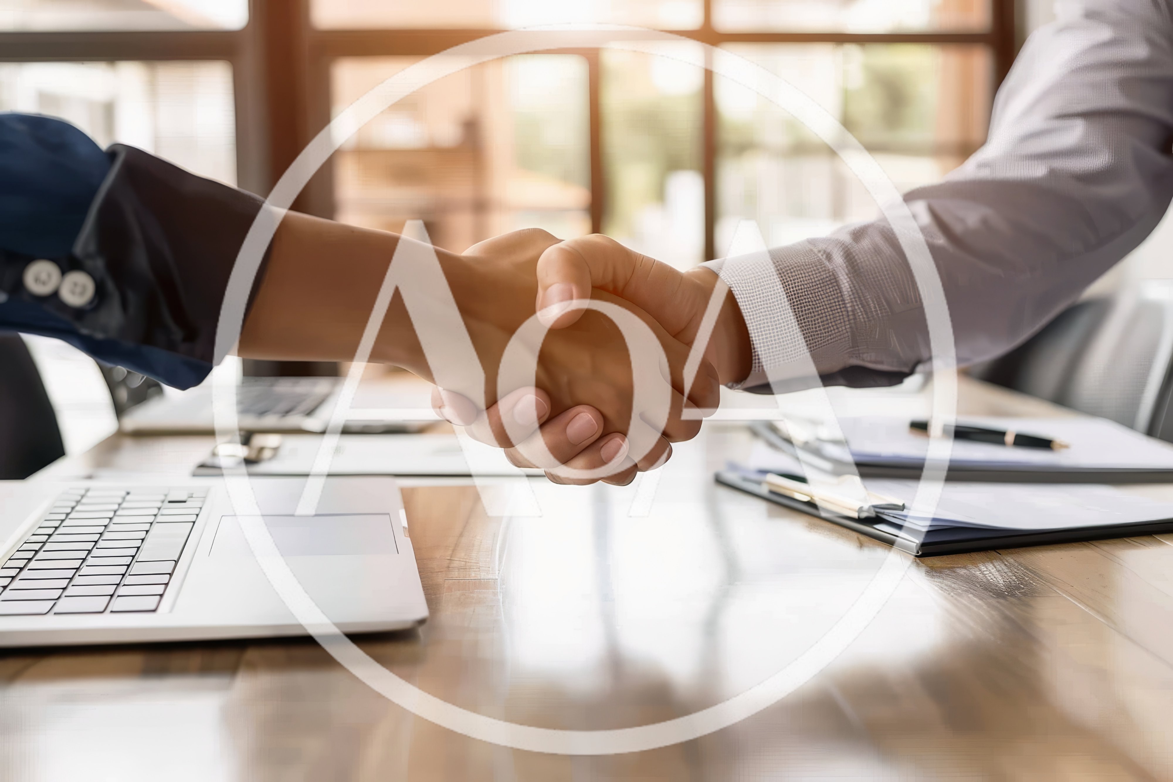 Business Professionals Shaking Hands Over Office Desk