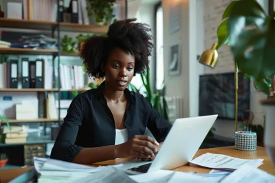 Professional Woman Working On Laptop In Home Office