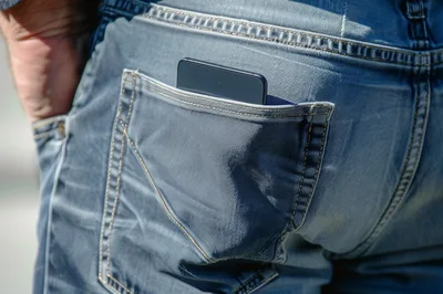 Smartphone Sticking Out Of A Back Pocket Of Blue Jeans
