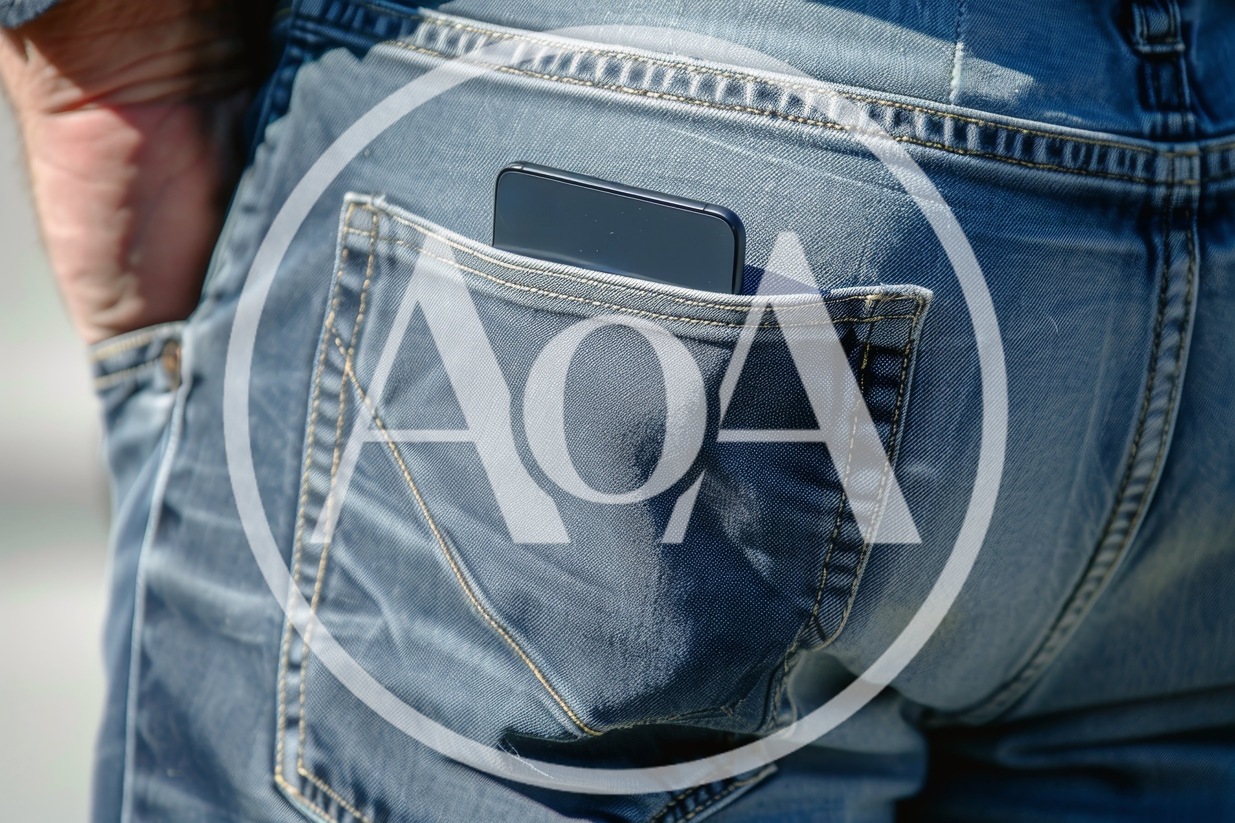 Smartphone Sticking Out Of A Back Pocket Of Blue Jeans