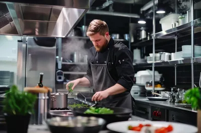 Professional Chef Cooking In A Modern Restaurant Kitchen