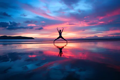 Woman Practicing Yoga Pose on Beach at Sunset