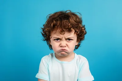 Angry Young Boy With Curly Hair
