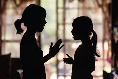 Silhouette of Mother and Daughter Talking