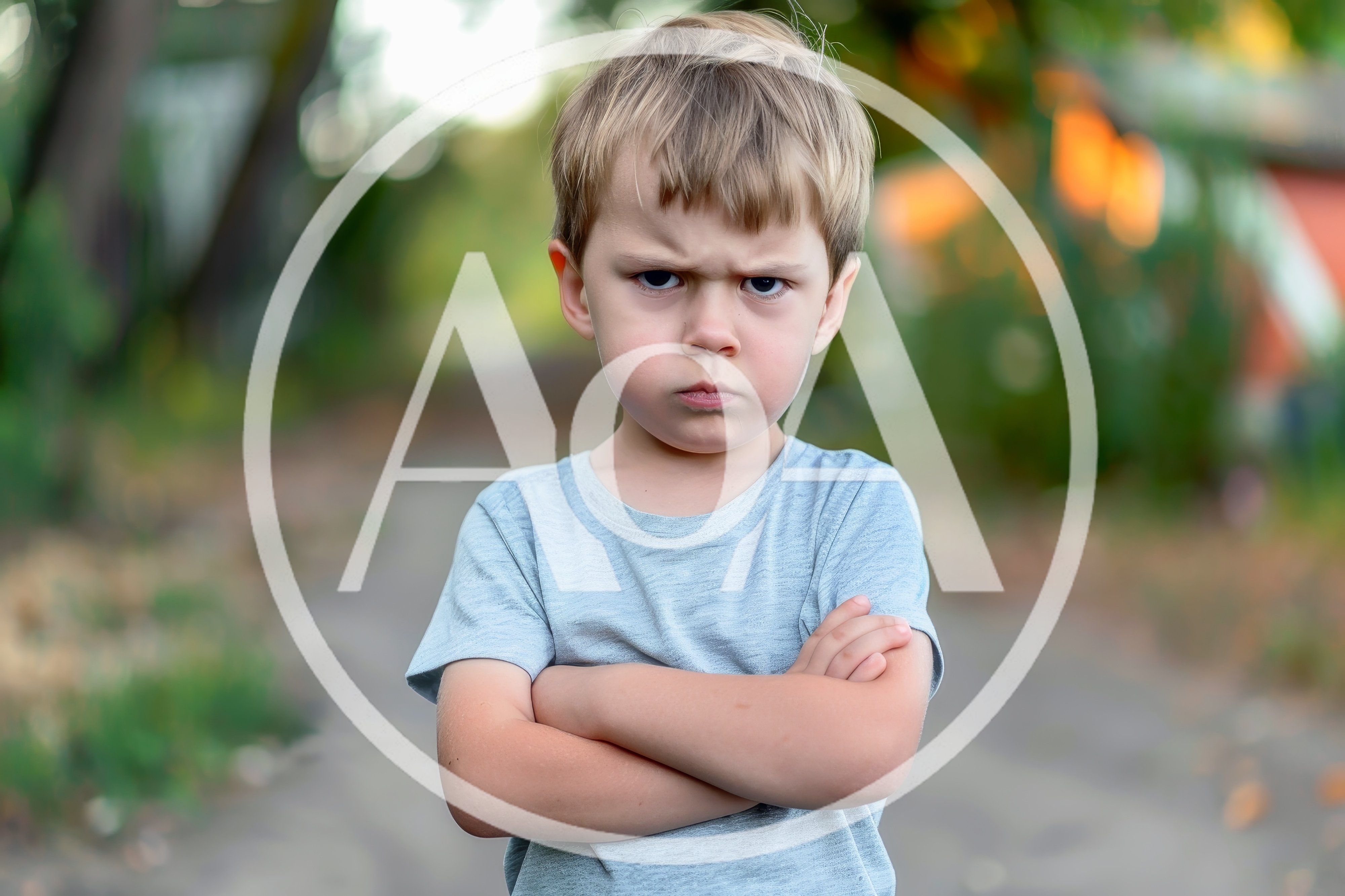 Angry Young Boy With Crossed Arms