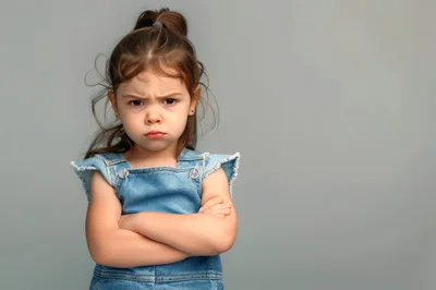 Angry Little Girl With Crossed Arms