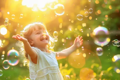 Happy Little Girl Playing With Bubbles Outdoors