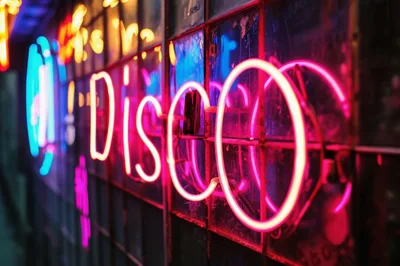 Neon Disco Sign Glowing On A Dark Window