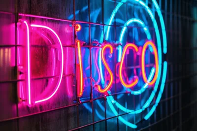 Neon Disco Sign Mounted On A Metal Grid Wall