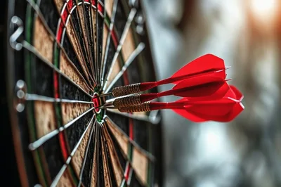 Three Red Darts Hitting The Bullseye