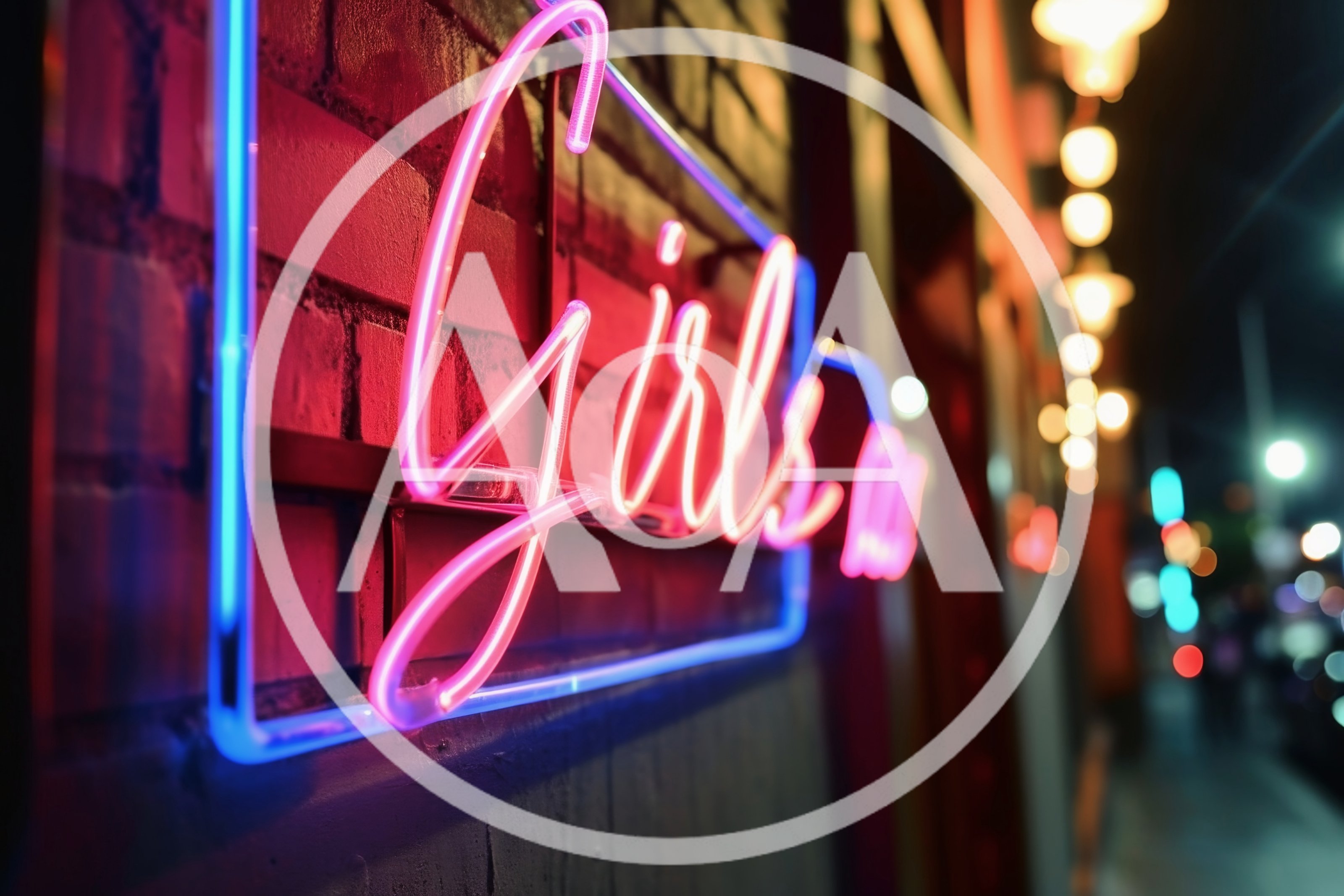 Neon Girls Sign On A Brick Wall At Night