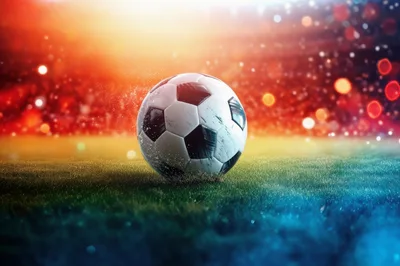Soccer Ball Resting On Stadium Grass At Night