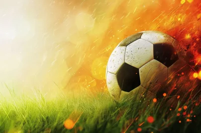 Soccer Ball Resting On Grass With Fiery Background