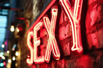 Neon Sexy Sign Mounted On A Brick Wall
