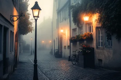 Cobblestone Street In A Foggy European Town At Dusk