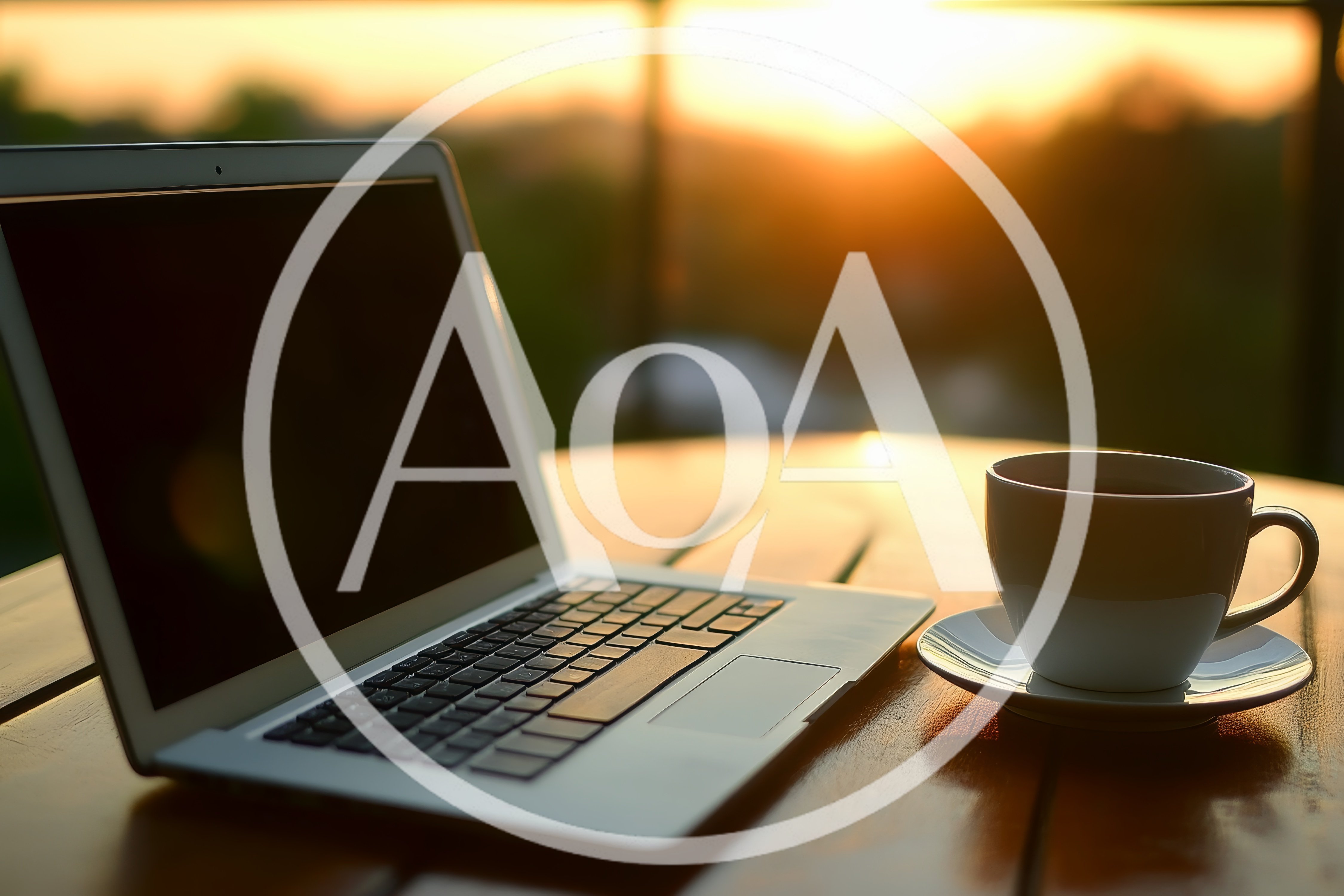 Laptop And Coffee Cup On Outdoor Table At Sunset