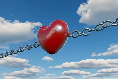Red Heart Connected By Metal Chains In The Sky