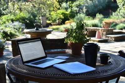 Laptop And Coffee On Outdoor Garden Table