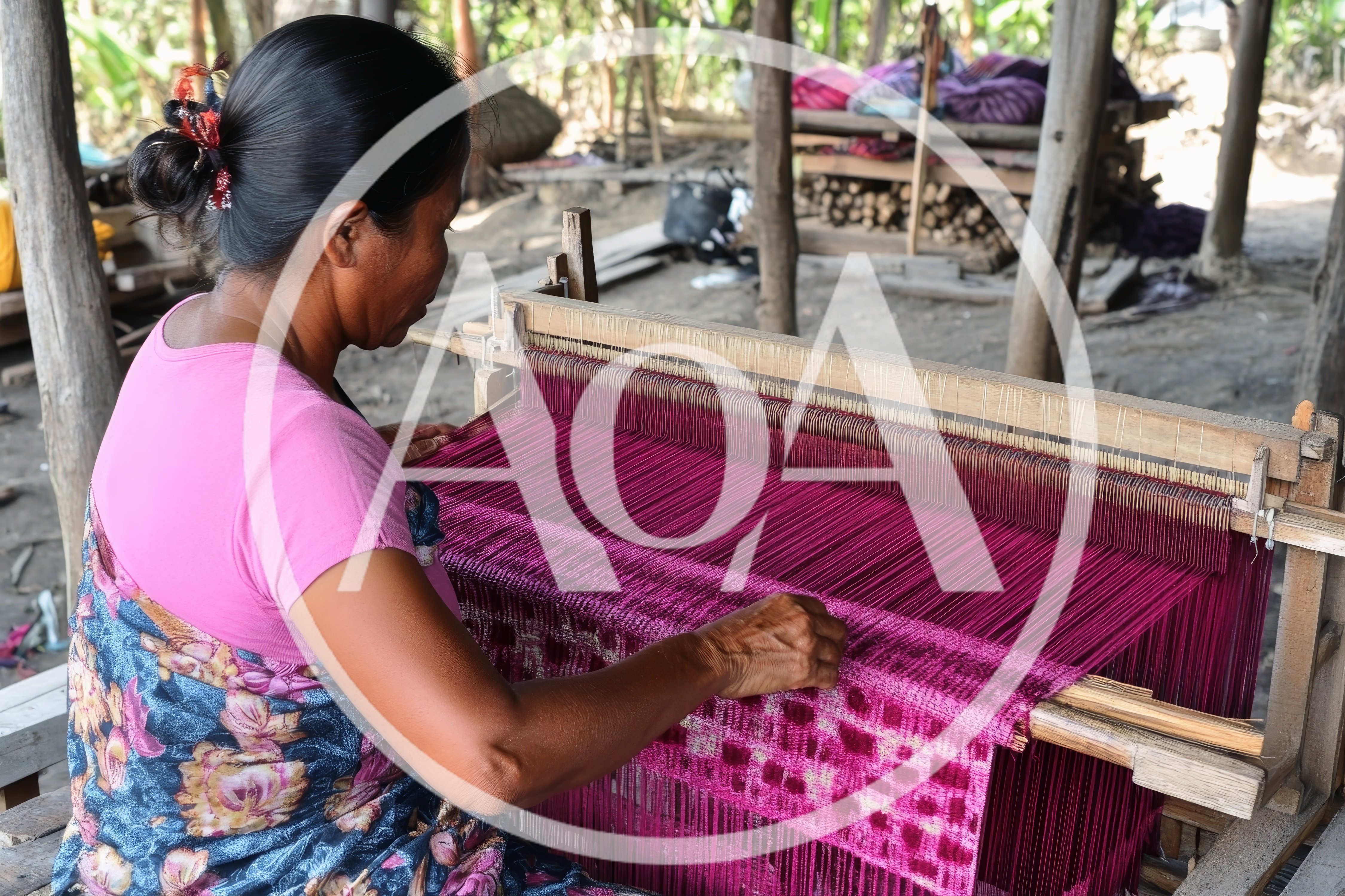 Indigenous Woman Weaving Traditional Textile on Wooden Loom