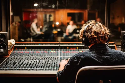 Sound Engineer Mixing Music In Professional Recording Studio