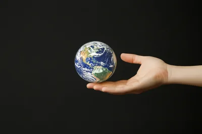 Human Hand Holding A Miniature Earth Globe