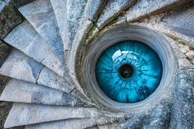 Spiral Stone Staircase Leading To A Blue Eye