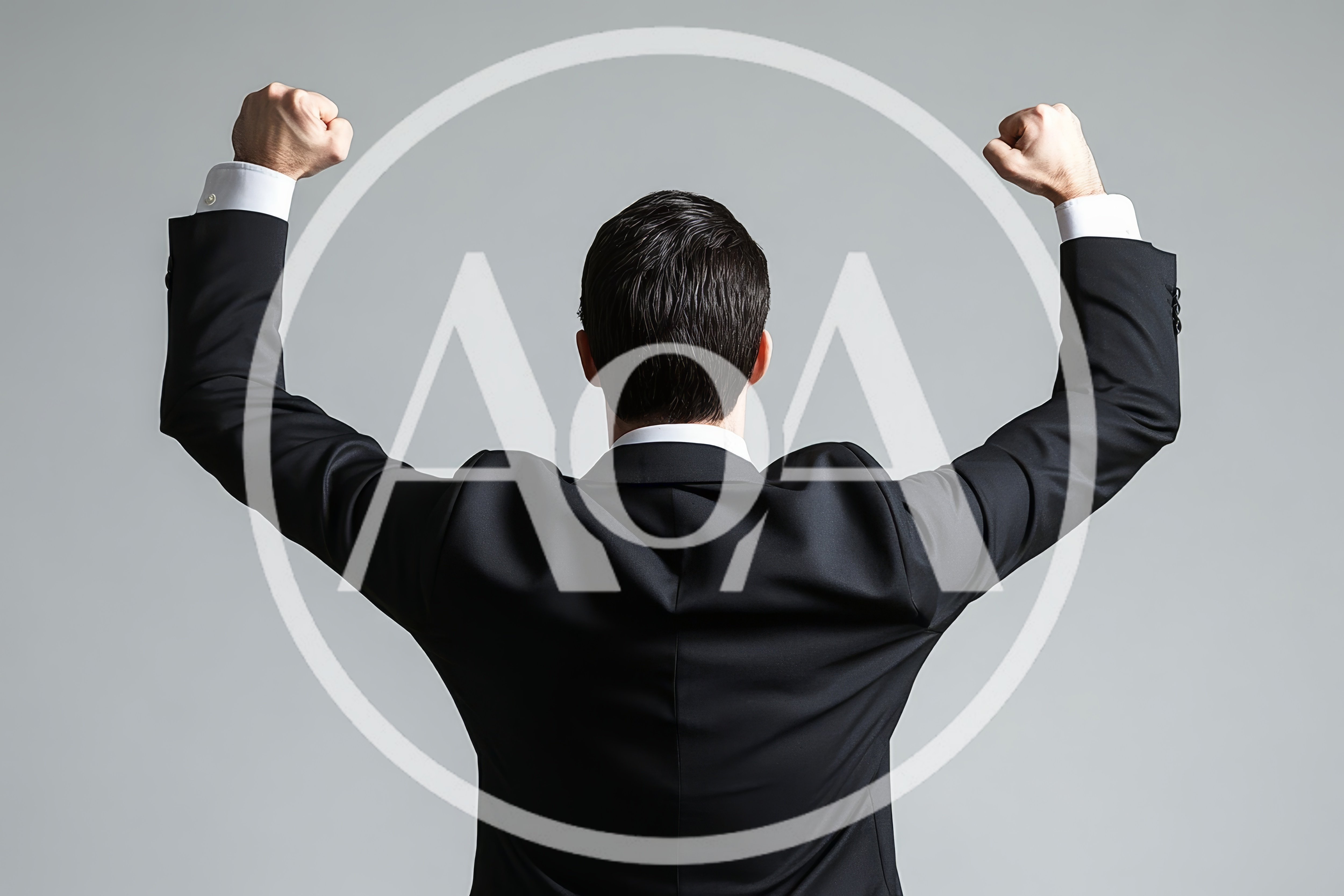Businessman Celebrating Success With Arms Raised In Victory