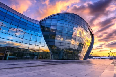 Modern Glass Airport Terminal Building At Sunset