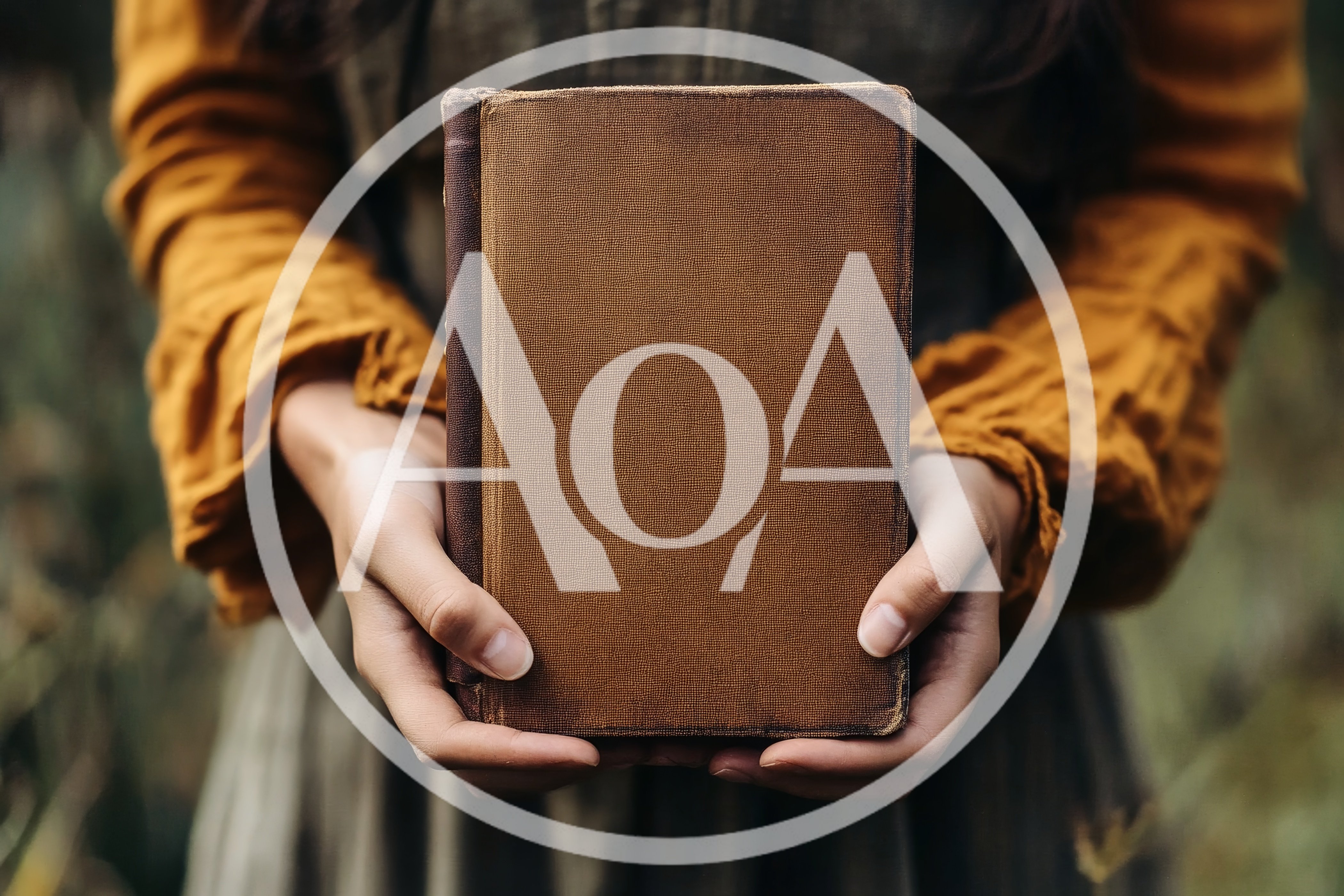 Person Holding An Antique Brown Hardcover Book