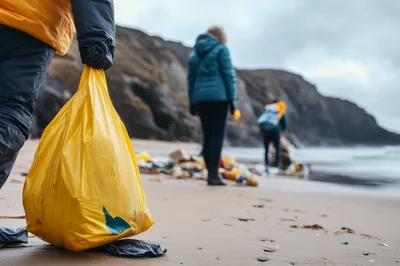 Volunteers Cleaning Plastic Waste From A Sandy Beach