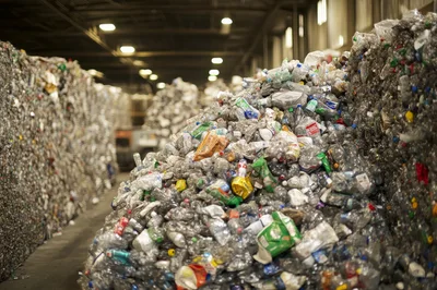 Large Piles Of Recycled Plastic Bottles In Warehouse