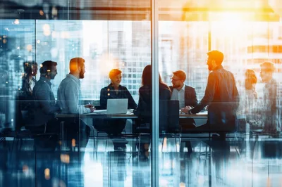 Business Professionals Collaborating in a Modern Glass Office