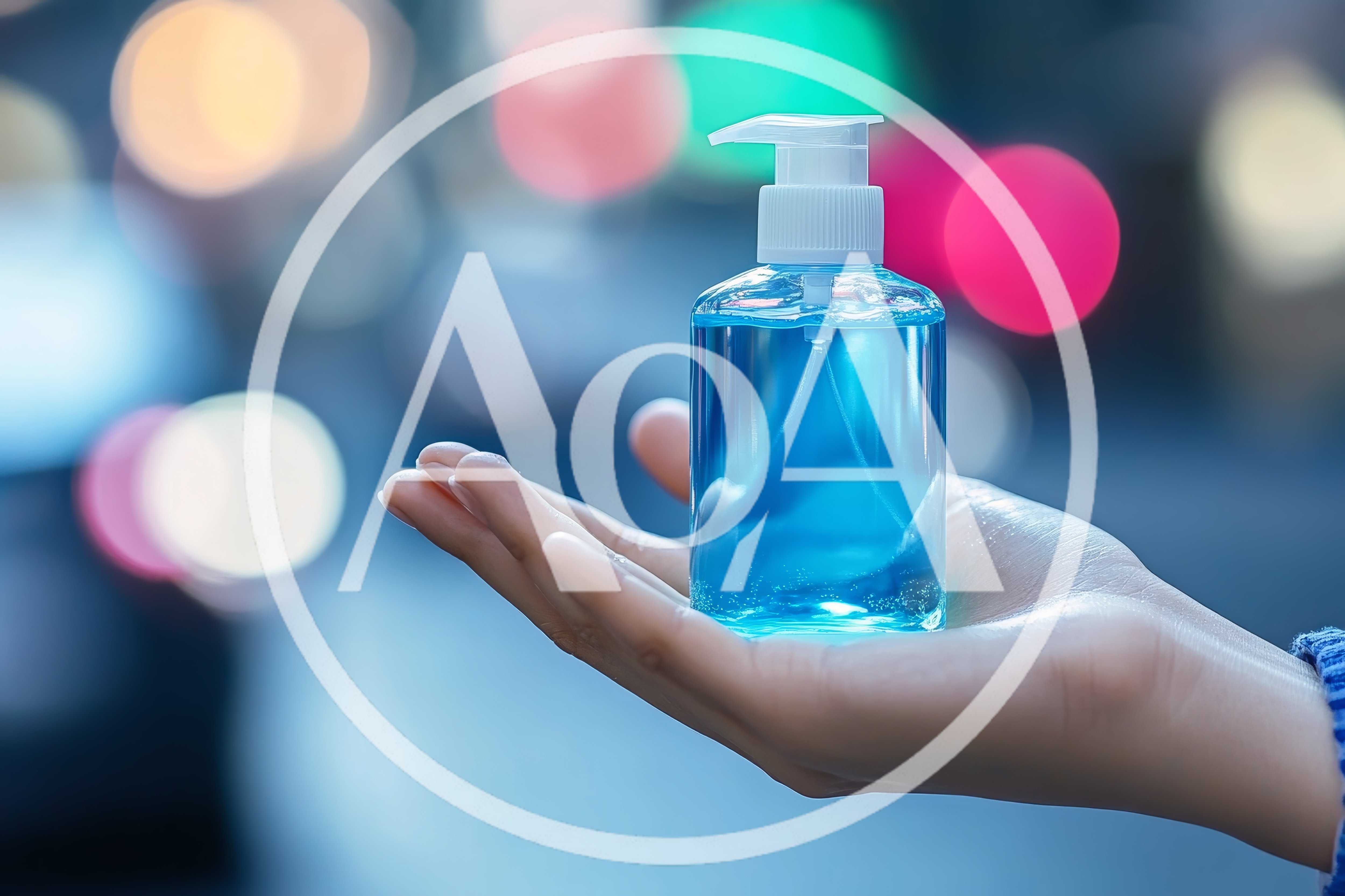 Hand Holding A Bottle Of Blue Hand Sanitizer