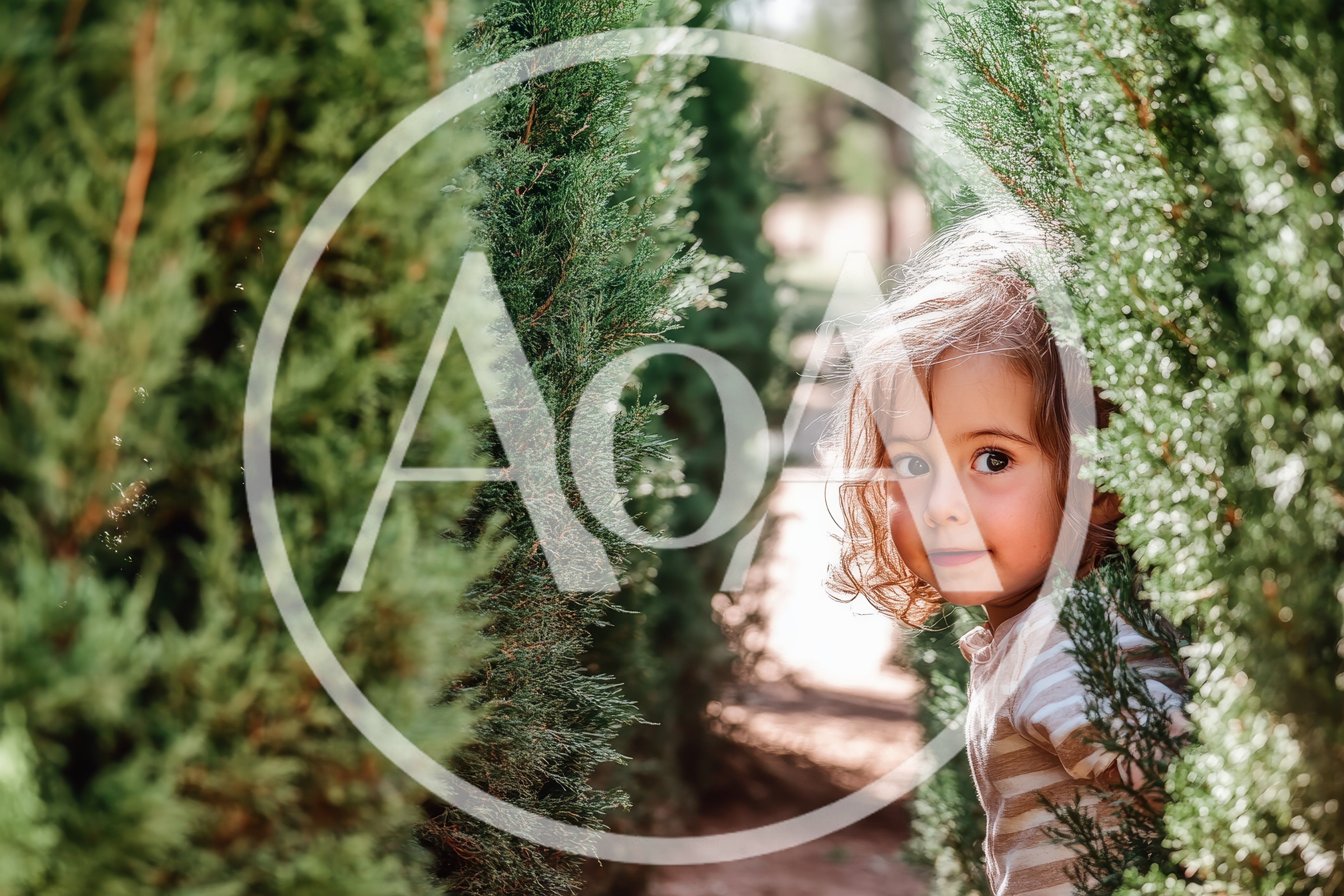 Little Girl Peeking Through Green Garden Hedges