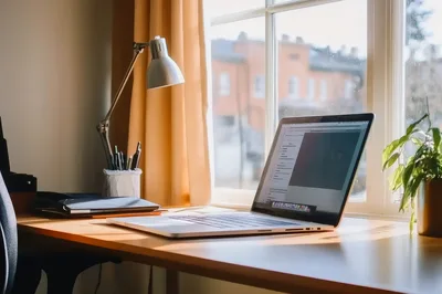Laptop On A Desk By A Sunny Window