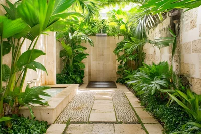 Outdoor Tropical Shower With Stone Basin And Lush Foliage