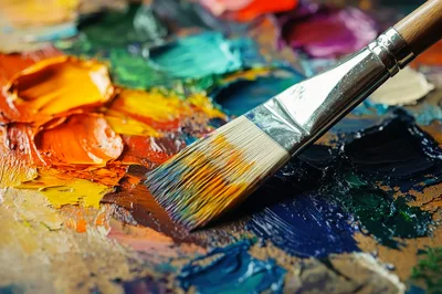 Artist Paintbrush Resting On A Colorful Oil Palette