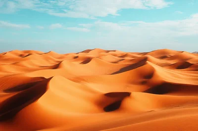 Vast Golden Sand Dunes Under A Clear Blue Sky