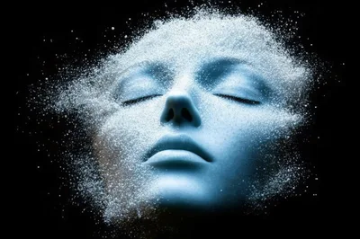 Digital Human Face Dissolving Into Glowing Particles