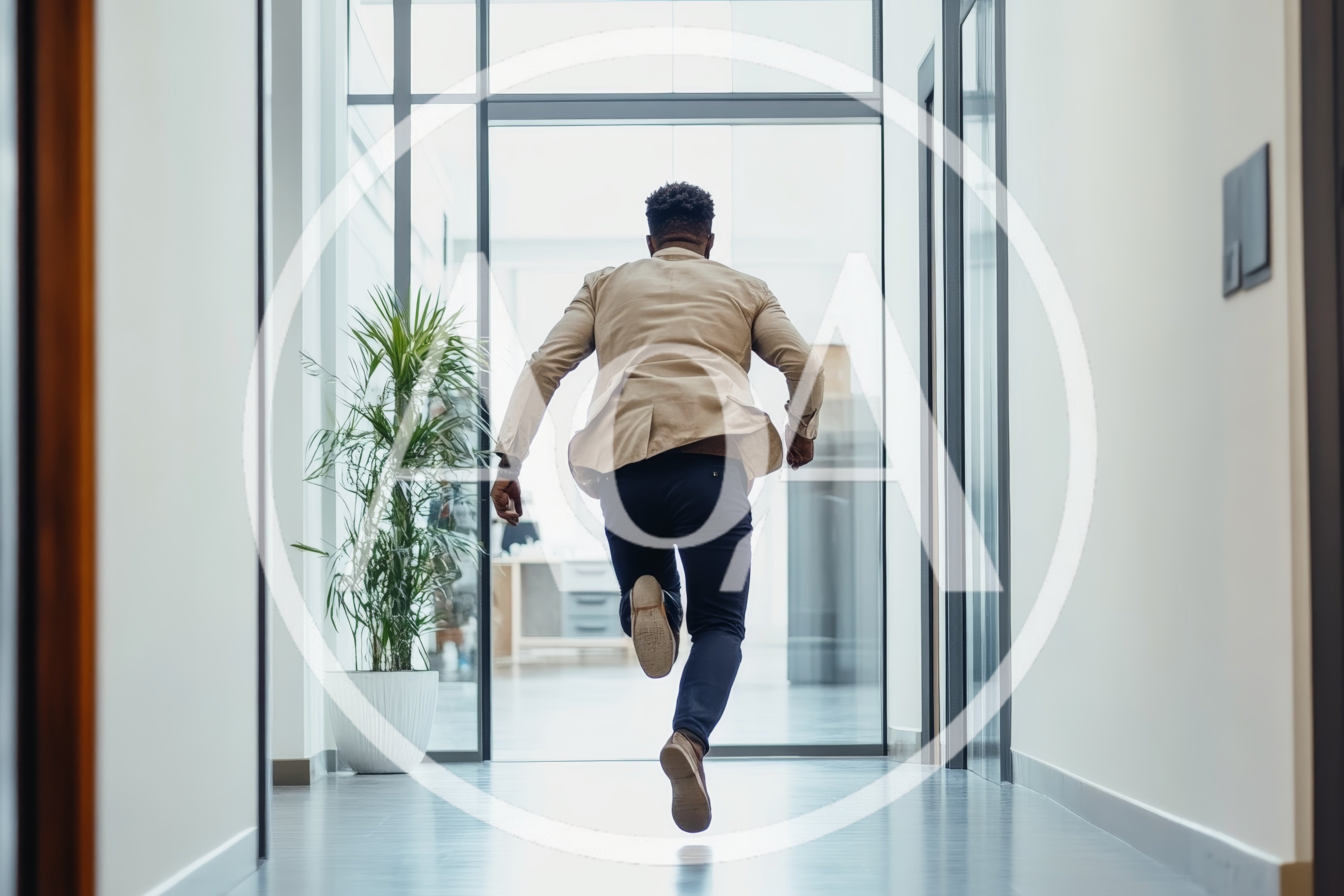 Businessman Running Down A Modern Office Hallway