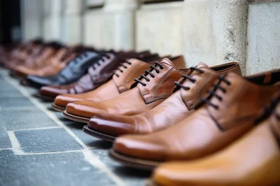 Row Of Classic Leather Dress Shoes On Stone Pavement