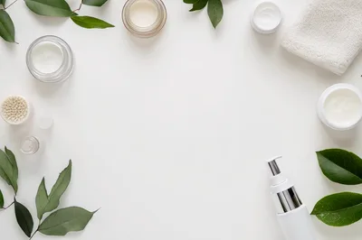 Flat Lay Skincare Products With Green Leaves