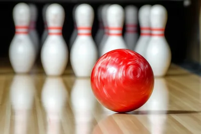 Red Bowling Ball Rolling Toward Pins