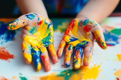 Child Hands Covered In Colorful Finger Paint